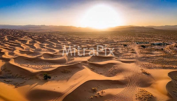 desert-landscape-with-sand-dunes-and-lone-road-aerial-view-of-arid-terrain-at-sunset