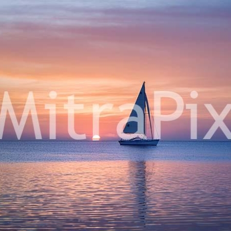 lone-sailboat-on-a-tranquil-ocean-at-sunrise