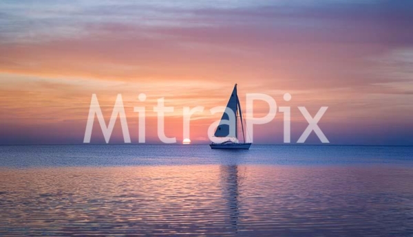 lone-sailboat-on-a-tranquil-ocean-at-sunrise