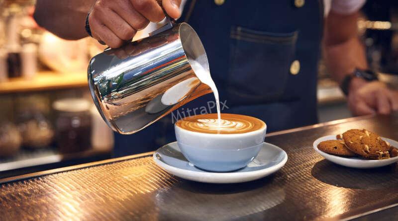 Barista Pouring Artisan Coffee with Latte Art